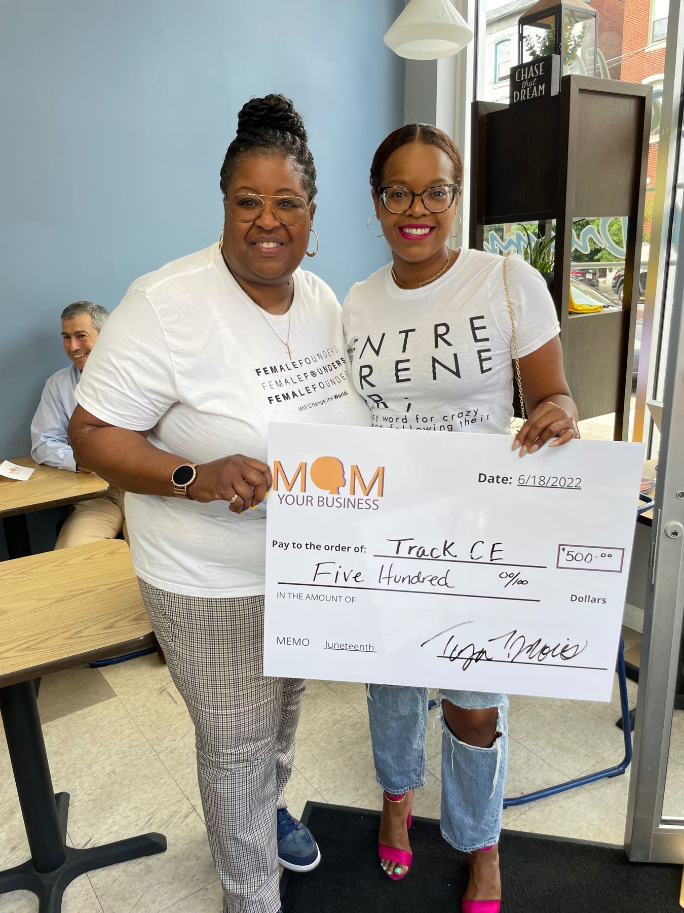 Amy receiving a grant check for TrackCE